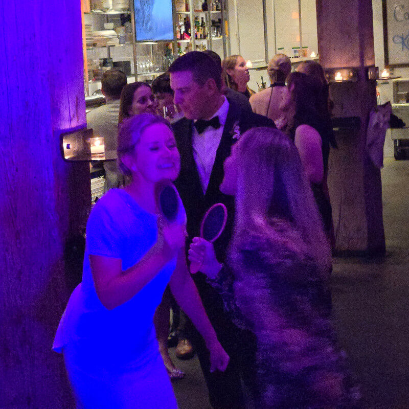 Guests celebrating on the dance floor with hair brushes